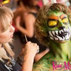 Kiss My Fairy staff hand painting male client as a green monster